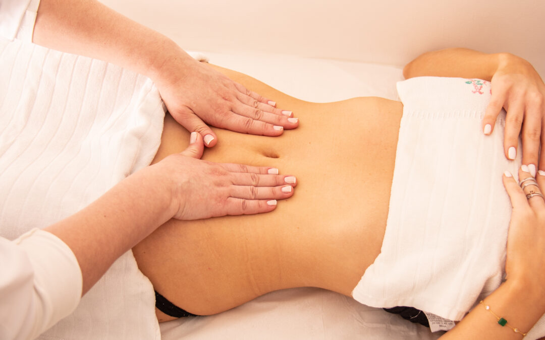 Massage therapist starting manual lymphatic drainage post-liposuction